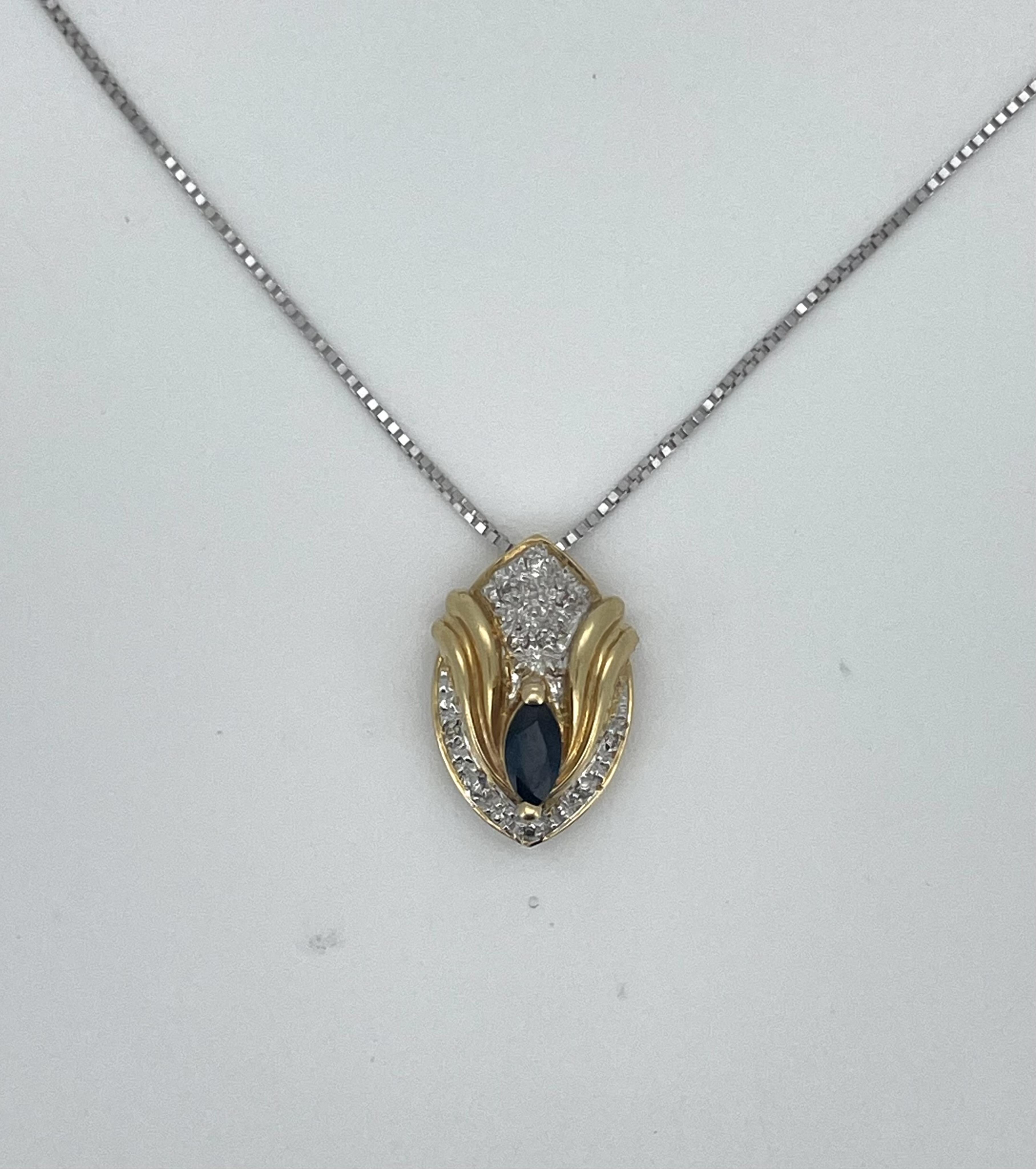 A modern 18ct two colour gold, sapphire and diamond cluster set navette shaped pendant, 16mm, on an 18ct white gold fine link necklace, gross weight 4 grams.